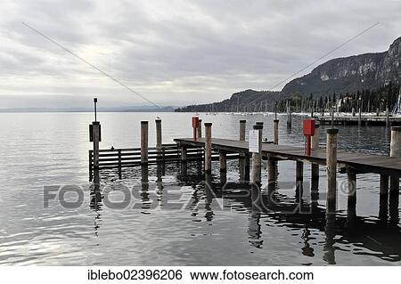 "Jetty at the shore of Lake Garda, Garda, Italy, Europe" View Large Photo Image Stock Photograph - "Jetty at the shore of Lake Garda, Garda, Italy, Europe". Fotosearch