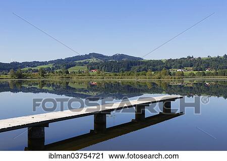 "Jetty on Haslacher See lake, Auersberg hill at back, Bernbeuren, Pfaffenwinkel region, Upper Bavaria, Bavaria, Germany, Europe" View Large Photo Image Stock Image - "Jetty on Haslacher See lake, Auersberg hill at back, Bernbeuren, Pfaffenwinkel region, Upper Bavaria, Bavaria, Germany, Europe". Fotosearch