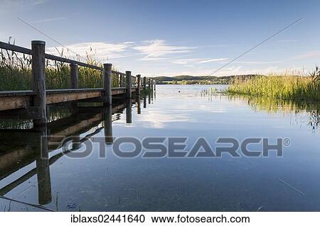 Stock Image - "Jetty on Lake Constance with a reflection, Reichenau Island, Lake Constance, Baden-Wuerttemberg, Germany, Europe, PublicGround, Europe". Fotosearch