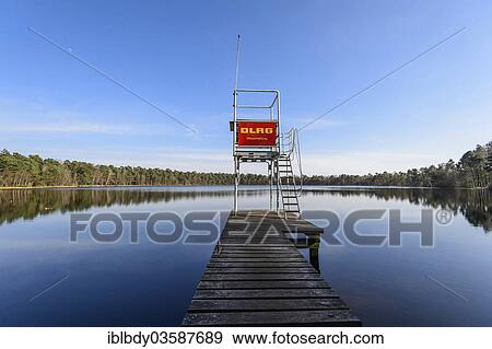 "Jetty with a life guard tower of the DLRG, German Life Saving Association, at a swimming lake, Grosser Bullensee lake, Kirchwalsede, Lower Saxony, Germany, Europe" View Large Photo Image Stock Photo - "Jetty with a life guard tower of the DLRG, German Life Saving Association, at a swimming lake, Grosser Bullensee lake, Kirchwalsede, Lower Saxony, Germany, Europe". Fotosearch