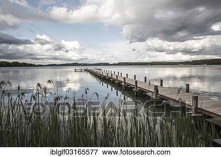 Stock Photo - "Jetty with reeds at Woerthsee Lake, Schlagenhofen, Inning, Bavaria, Germany, Europe". Fotosearch