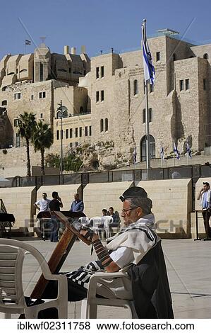 "Jew praying seated with a tefillin on his forehead and phylacteries on his arm, houses of the Jewish Quarter at back, Muslim Quarter, Jerusalem, Israel, Middle East, Southwest Asia, Asia" View Large Photo Image Stock Photo - "Jew praying seated with a tefillin on his forehead and phylacteries on his arm, houses of the Jewish Quarter at back, Muslim Quarter, Jerusalem, Israel, Middle East, Southwest Asia, Asia". Fotosearch