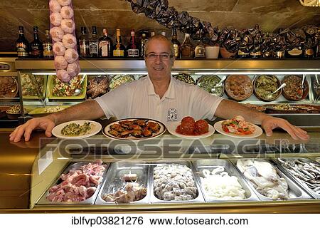 "Juan Jose Nieto, owner of the """"La Cueva"""" tapas bar, La Lonja district, Palma, Mallorca, Balearic Islands, Spain, Europe" View Large Photo Image Stock Photograph - "Juan Jose Nieto, owner of the """"La Cueva"""" tapas bar, La Lonja district, Palma, Mallorca, Balearic Islands, Spain, Europe". Fotosearch