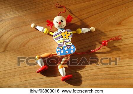 Stock Photograph - Jumping jack lying on wooden background. Fotosearch