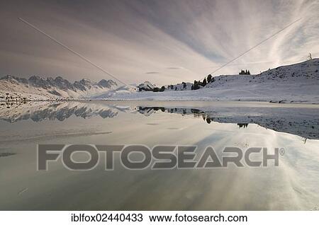 Stock Image - "Kalkkoegel mountain range reflected in a small lake, Tyrol, Austria, Europe". Fotosearch
