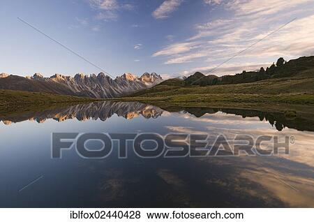 Stock Photo - "Kalkkoegel mountain range reflected in a small mountain lake, Tyrol, Austria, Europe". Fotosearch