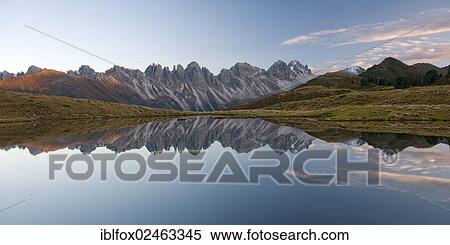 Stock Photography - "Kalkkoegel mountain range reflected in a small lake, Tyrol, Austria, Europe". Fotosearch
