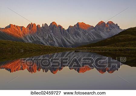 Stock Photo - "Kalkkoegel mountains reflected in lake, Tyrol, Austria, Europe". Fotosearch