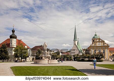 Picture - "Kapellplatz square with Marienbrunnen, Magdalena church, town hall and the Shrine of Our Lady of Altotting, Altotting District, Upper Bavaria, Bavaria, Germany, Europe". Fotosearch