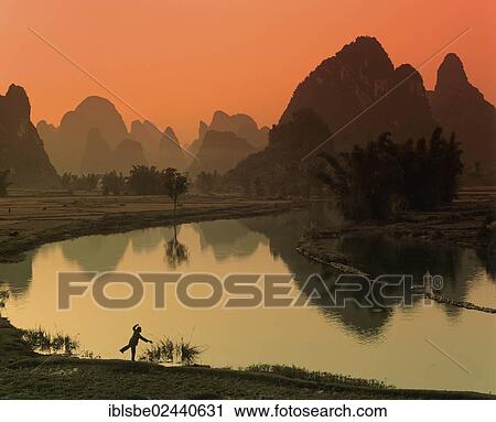 "Karst mountain landscape, man doing Tai Chi beside the Yulong River, Yangshuo, Li Jiang River, Guilin, Guangxi, China, Asia" View Large Photo Image Stock Image - "Karst mountain landscape, man doing Tai Chi beside the Yulong River, Yangshuo, Li Jiang River, Guilin, Guangxi, China, Asia". Fotosearch