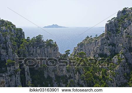 "Karst rocks in the rocky bay Calanque d'En-Vau, Ile de Riou at back, Calanques National Park, Cassis, Departement Bouches-du-Rhone, Region Provence-Alpes-Cote d? ÇÖAzur d? ÇÖAzur, France, Europe" View Large Photo Image Stock Image - "Karst rocks in the rocky bay Calanque d'En-Vau, Ile de Riou at back, Calanques National Park, Cassis, Departement Bouches-du-Rhone, Region Provence-Alpes-Cote d? ÇÖAzur d? ÇÖAzur, France, Europe". Fotosearch