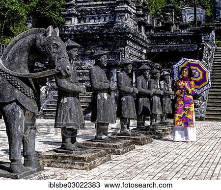 "Khai Dinh Tomb, Mandarin soldiers made of stone, young woman wearing a colourful traditional costume, Hue, Provinz Thua Thien-Hue, Vietnam, Asia" View Large Photo Image Stock Image - "Khai Dinh Tomb, Mandarin soldiers made of stone, young woman wearing a colourful traditional costume, Hue, Provinz Thua Thien-Hue, Vietnam, Asia". Fotosearch