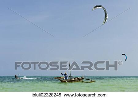 "Kite surfers and a fisherman in a fishing boat, Ngalawa, off Bwejuu, east coast of Zanzibar, Tanzania, Africa" View Large Photo Image Stock Photography - "Kite surfers and a fisherman in a fishing boat, Ngalawa, off Bwejuu, east coast of Zanzibar, Tanzania, Africa". Fotosearch