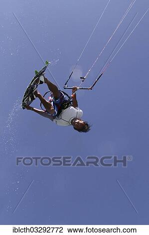 "Kitesurfer jumping with splashing water, El Gouna, Red Sea Governorate, Egypt, Africa" View Large Photo Image Stock Image - "Kitesurfer jumping with splashing water, El Gouna, Red Sea Governorate, Egypt, Africa". Fotosearch