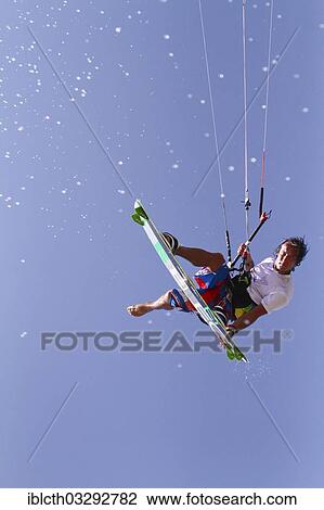 "Kitesurfer jumping with splashing water, El Gouna, Red Sea Governorate, Egypt, Africa" View Large Photo Image Stock Image - "Kitesurfer jumping with splashing water, El Gouna, Red Sea Governorate, Egypt, Africa". Fotosearch