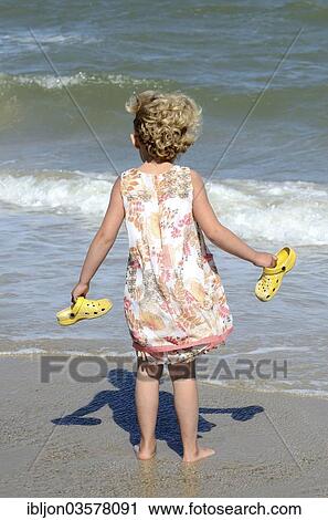"Kleines Madchen am Strand sieht auf die Wellen, Skagen, Jutland, Denmark, Europe" View Large Photo Image Stock Image - "Kleines Madchen am Strand sieht auf die Wellen, Skagen, Jutland, Denmark, Europe". Fotosearch