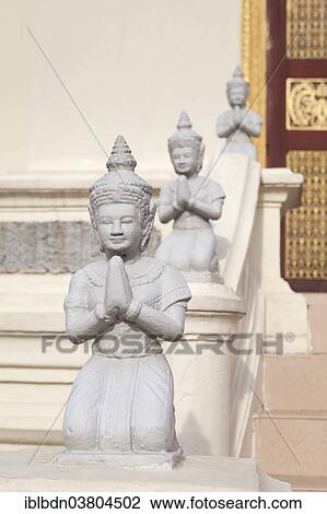 Stock Image - "Kneeling statues adorn the Mondapa of Satra and Tripitaka, housing the Royal Library, Royal Palace, Phnom Penh, Cambodia, Asia". Fotosearch