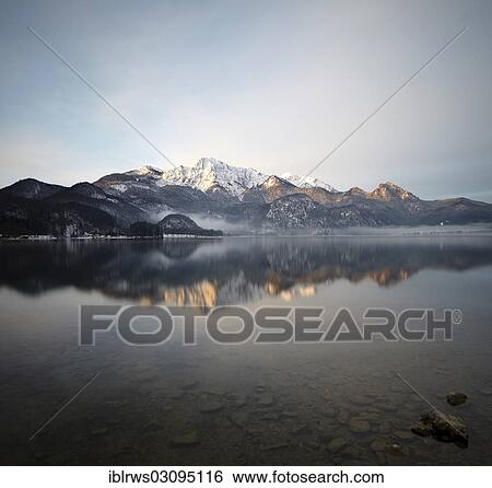 Stock Photograph - "Kochelsee Lake or Lake Kochel with Mt Herzogstand at sunrise, Kochelsee, Kochel am See, Upper Bavaria, Bavaria, Germany, Europe". Fotosearch