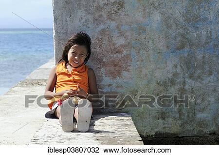 Stock Image - "Kuna Indian girl in a Kuna Indian village, Nalunega, San Blas Islands, Panama, North America". Fotosearch