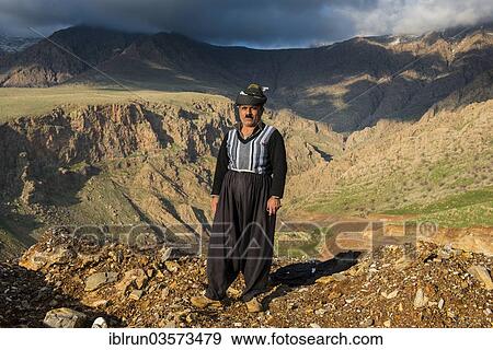 "Kurdish shepherd standing on the edge of a canyon right above Ahmed Awa, Ahmed Awa, Iraqi Kurdistan, Iraq, Asia" View Large Photo Image Stock Photo - "Kurdish shepherd standing on the edge of a canyon right above Ahmed Awa, Ahmed Awa, Iraqi Kurdistan, Iraq, Asia". Fotosearch