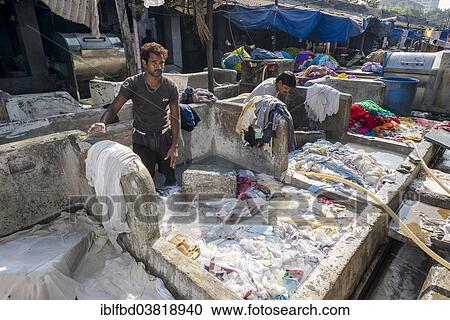 Stock Image - "Labourers are washing clothes at Mahalaxmi Dhobi Ghat, laundry district of Mumbai, Maharashtra, India, Asia". Fotosearch