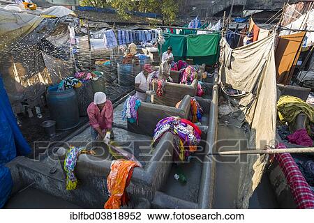 Stock Image - "Labourers are washing clothes at Mahalaxmi Dhobi Ghat, laundry district of Mumbai, Maharashtra, India, Asia". Fotosearch