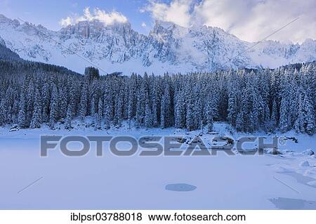 "Lago di Carezza in the first snow of the season, Passo di Costalunga, Carezza, Bolzano, South Tyrol, Italy, Europe" View Large Photo Image Stock Photo - "Lago di Carezza in the first snow of the season, Passo di Costalunga, Carezza, Bolzano, South Tyrol, Italy, Europe". Fotosearch