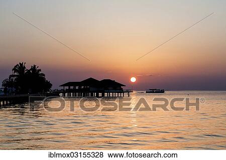 Stock Photo - "Lagoon with a jetty and a restaurant on Paradise Island or Lankanfinolhu, Indian Ocean, Lankanfinolhu, North Male Atoll, Maldives, Asia". Fotosearch