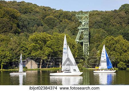 Picture - "Lake Baldeneysee in Essen, Essener Segelwoche sailing festival, colliery tower of the former Carl-Funke coal mine, Essen-Heisingen, North Rhine-Westphalia, Germany, Europe". Fotosearch
