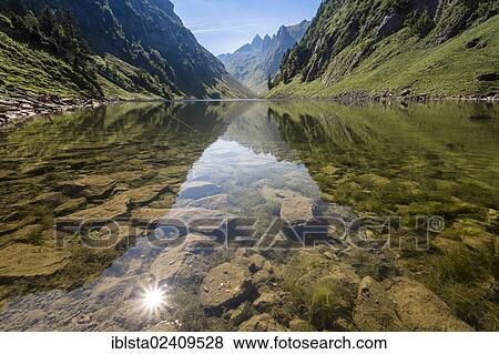 "Lake Faehlensee, sun being reflected in the lake, Alpstein, Appenzell, Switzerland, Europe" View Large Photo Image Stock Photo - "Lake Faehlensee, sun being reflected in the lake, Alpstein, Appenzell, Switzerland, Europe". Fotosearch