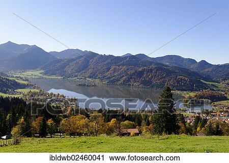 Stock Image - "Lake Schliersee and the Parish Church of St. Sixtus as seen from Schliersberg mountain in autumn, Upper Bavaria, Bavaria, Germany, Europe". Fotosearch