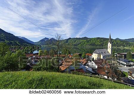 Stock Photograph - "Lake Schliersee in spring, Parish Church of St. Sixtus at the back, Upper Bavaria, Bavaria, Germany, Europe". Fotosearch