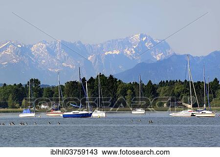 "Lake Starnberg in front of Zugspitze Mountain, Wetterstein Mountains, Fuenfseenland or Five Lakes region, Sankt Heinrich, Upper Bavaria, Bavaria, Germany, Europe" View Large Photo Image Stock Image - "Lake Starnberg in front of Zugspitze Mountain, Wetterstein Mountains, Fuenfseenland or Five Lakes region, Sankt Heinrich, Upper Bavaria, Bavaria, Germany, Europe". Fotosearch