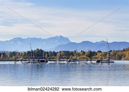 Stock Image - Lake Starnberg near Sankt Heinrich, Zugspitze mountain at the back, Muensing, Fuenfseenland region, Upper Bavaria, Bavaria, Germany, Europe. Fotosearch