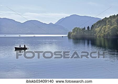 "Lake Walchen with a row boat, Hirschhoernlkopf Mountain at the rear, Walchensee, Kochel am See, Upper Bavaria, Bavaria, Germany, Europe" View Large Photo Image Stock Image - "Lake Walchen with a row boat, Hirschhoernlkopf Mountain at the rear, Walchensee, Kochel am See, Upper Bavaria, Bavaria, Germany, Europe". Fotosearch