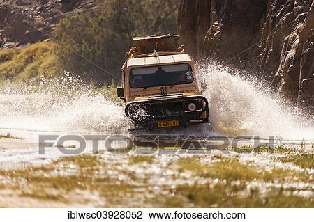 Stock Image - "Land Rover during a water crossing, Puros, Kaokoland, Namibia, Africa". Fotosearch