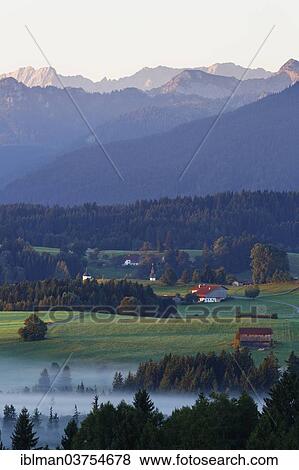 "Landscape in the Alpine Foreland, morning mood with fog, Bad Bayersoien, Saulgrub, Pfaffenwinkel region, Upper Bavaria, Bavaria, Germany, Europe" View Large Photo Image Stock Photo - "Landscape in the Alpine Foreland, morning mood with fog, Bad Bayersoien, Saulgrub, Pfaffenwinkel region, Upper Bavaria, Bavaria, Germany, Europe". Fotosearch