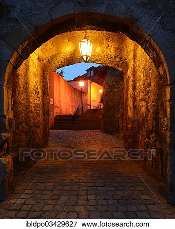 Stock Photo - "Lane passing underneath a stone archway at dusk, Hainburg an der Donau, Lower Austria, Austria, Europe". Fotosearch