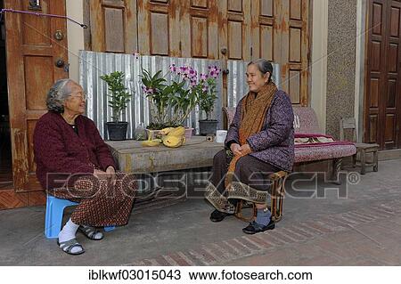 "Lao women wearing typical sarongs sitting in front of a house, Luang Prabang, Laos, Asia" View Large Photo Image Stock Image - "Lao women wearing typical sarongs sitting in front of a house, Luang Prabang, Laos, Asia". Fotosearch