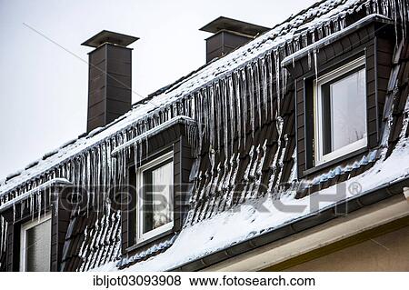 "Large icicles hanging from the eaves of a house, sign of a poorly heat-insulated roof, Essen, North Rhine-Westphalia, Germany, Europe" View Large Photo Image Stock Photo - "Large icicles hanging from the eaves of a house, sign of a poorly heat-insulated roof, Essen, North Rhine-Westphalia, Germany, Europe". Fotosearch