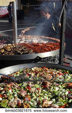 "Large pan containing ingredients for the paella in front of a giant barbecue at the annual All Saints Market in Cocentaina, Alicante province, Spain, Europe" View Large Photo Image Stock Photography - "Large pan containing ingredients for the paella in front of a giant barbecue at the annual All Saints Market in Cocentaina, Alicante province, Spain, Europe". Fotosearch