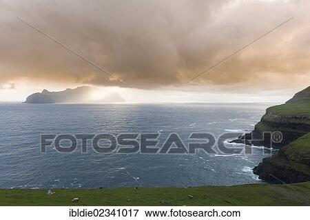 "Last evening sun rays over the island of Mykines in the North Atlantic, Faroe Islands, North Sea, Northern Europe, Europe" View Large Photo Image Stock Photo - "Last evening sun rays over the island of Mykines in the North Atlantic, Faroe Islands, North Sea, Northern Europe, Europe". Fotosearch