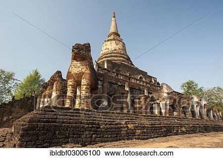Stock Image - "Laterite chedi with destroyed elephant statues, stepped temple of Wat Chang Lom, Si Satchanalai Historical Park, UNESCO World Heritage Site, Si Satchanalai, Sukhothai Province, Northern Thailand, Thailand, Asia". Fotosearch