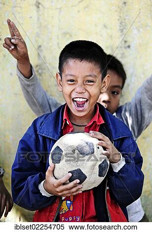 "Laughing Asian boy with a football in his hands, Burma, Myanmar, Southeast Asia, Asia" View Large Photo Image Stock Photography - "Laughing Asian boy with a football in his hands, Burma, Myanmar, Southeast Asia, Asia". Fotosearch