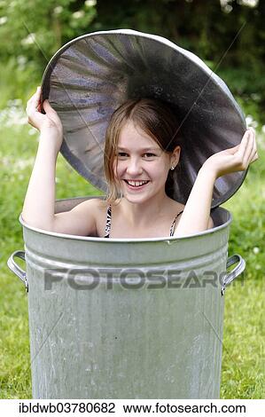 Laughing girl sitting in a barrel View Large Photo Image Stock Image - Laughing girl sitting in a barrel. Fotosearch