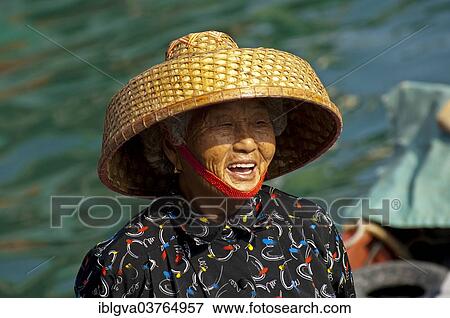 Stock Photo - "Laughing old Chinese fishmonger with straw hat, Sai Kung, Hong Kong, China, Asia". Fotosearch