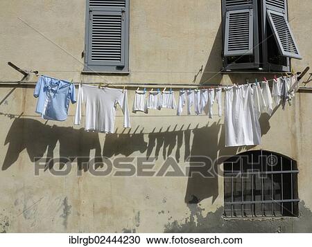 "Laundry hanging on a clothesline on a facade, Italy, Europe" View Large Photo Image Stock Image - "Laundry hanging on a clothesline on a facade, Italy, Europe". Fotosearch