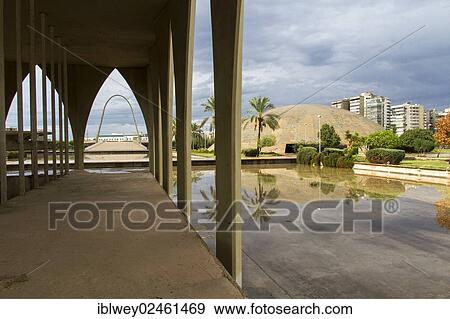 Stock Photo - "Lebanese Pavilion, Expo exhibition area, Rachid Karami International Fair, Tripoli, Lebanon. The Brazilian architect Oscar Niemeyer was planning the area in the early 1960s. Assembly Hall to the right, the concrete arch in the background on the left. ". Fotosearch