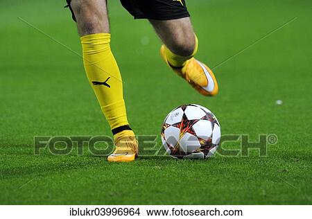 Picture - "Legs of a BVB player with adidas Champions League Ball, Signal Iduna Park, Dortmund, North Rhine-Westphalia, Germany, Europe". Fotosearch