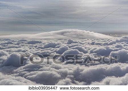Stock Photo - "Lenticular cloud, Cumulus lenticularis, above the top layer of clouds, North Rhine-Westphalia, Germany, Europe". Fotosearch